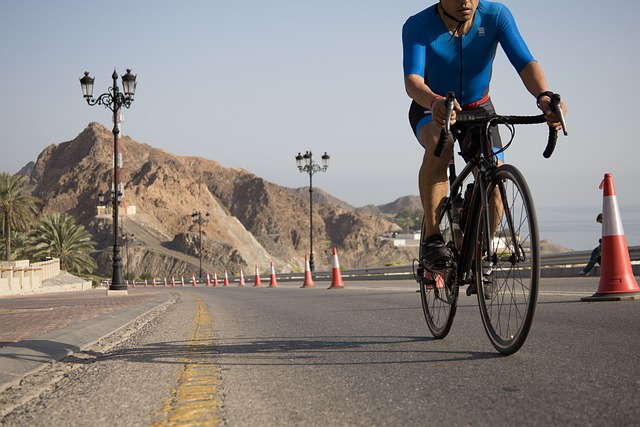 Man in blue riding road bike on road