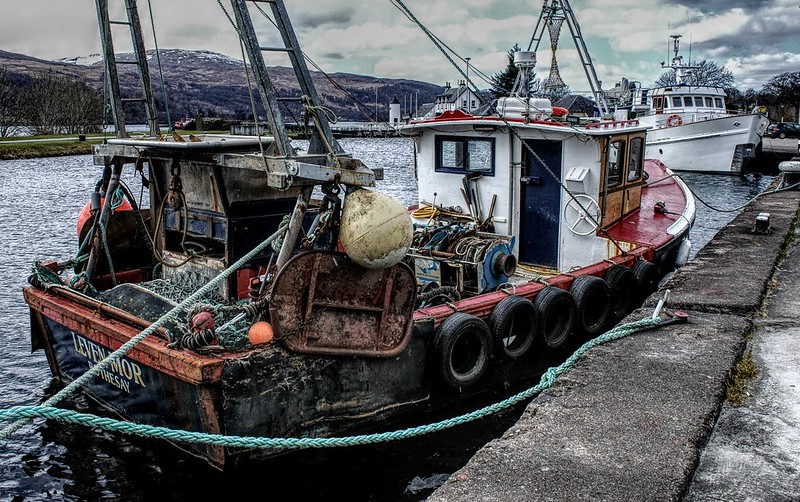 Older style fishing boat moored at dock